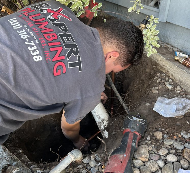 An emergency plumber providing urgent underground plumbing repair and specialized excavation services to resolve a critical water line issue.