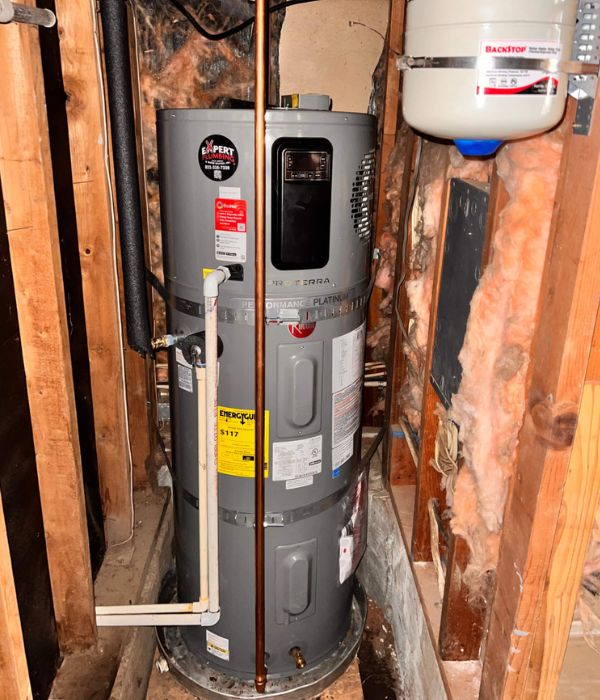 Plumber performing routine maintenance on a residential water heater | Water Heater Maintenance