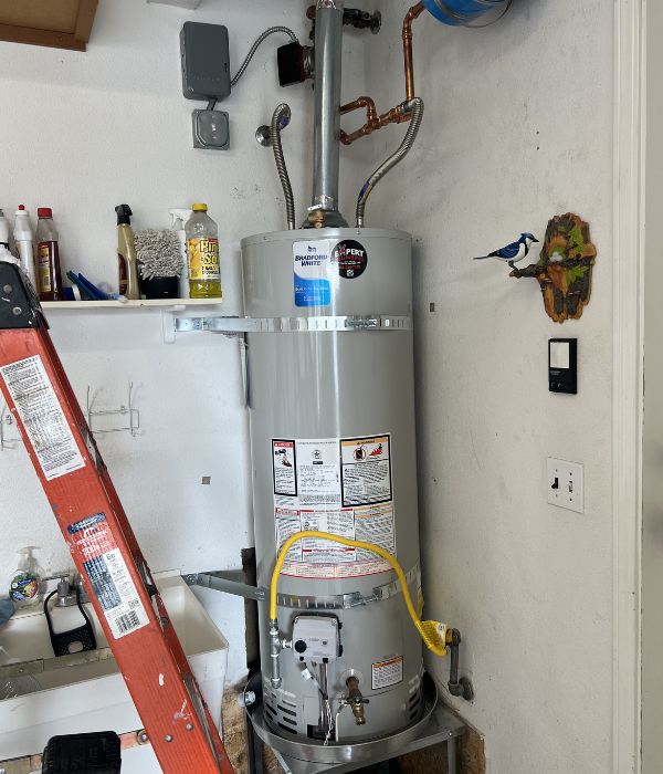 Technician replacing an old water heater with a new energy-efficient unit | Water Heater Installation & Replacements